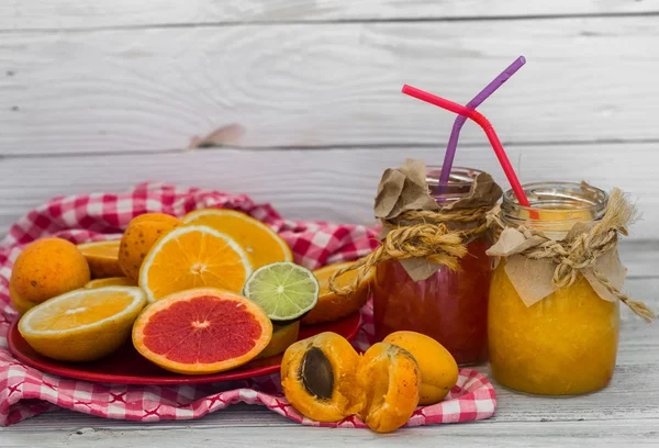 Lots of fresh fruit, cut on wooden background, drink, healthy food