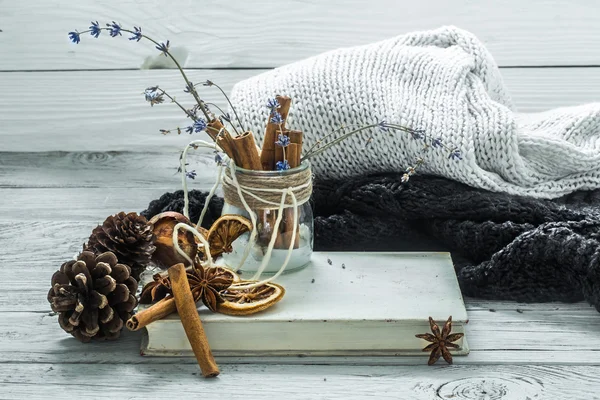 Cup of tea on a beautiful wooden background with winter sweater, old book