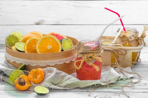 Lots of fresh fruit, cut on wooden background, drink, healthy food