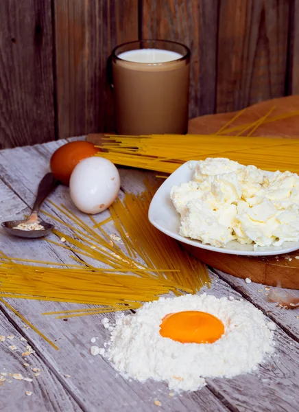 Cooking spaghetti on a wooden background milk eggs