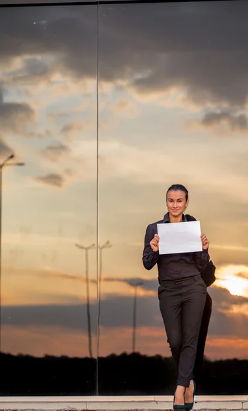 Beautiful business girl with white piece of paper