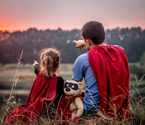 Little girl with dad dressed in super heroes, happy loving family