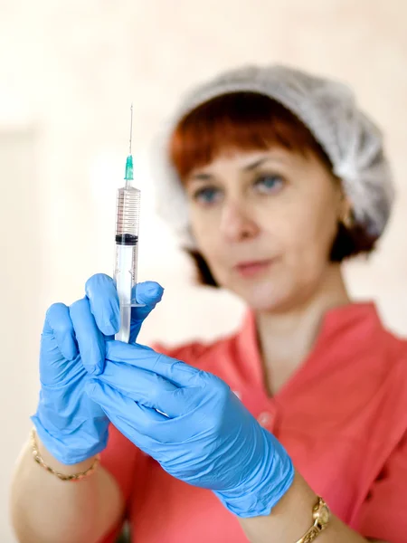 The nurse prepares the infusion and injection in the clinic