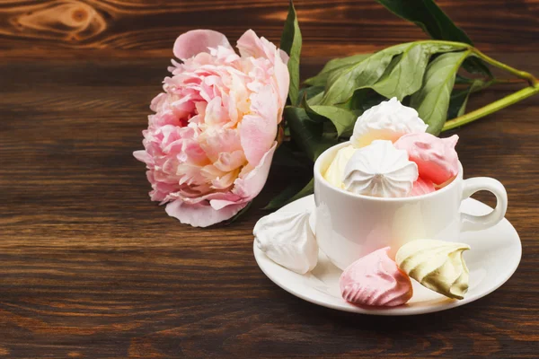 Cup with light pink and white meringues