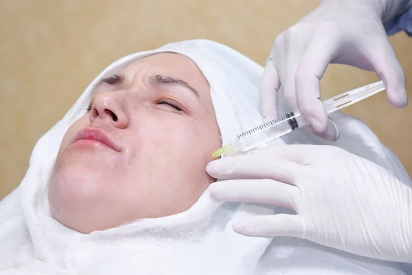 Cosmetic treatment with anti-age mixture injection in a clinic