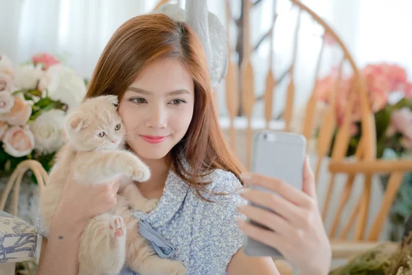 Selfie cat with a cute little girl .