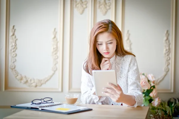 Woman  with laptop watching sad movie on tablet computer.