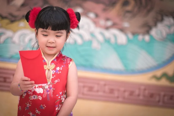 The China girl  in chinese dress  with chinese temple background