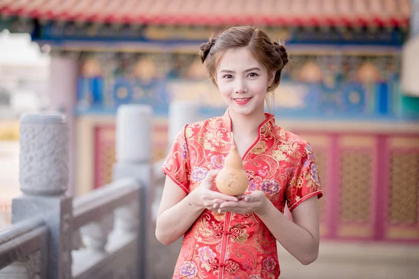 The Asian Chinese woman in Traditional Chinese hold calabash