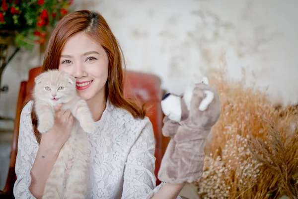 Cute girl and cat Playing with Sock Puppets