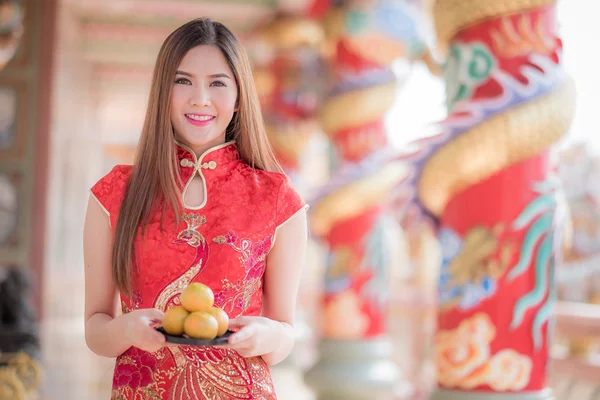 The Asian Chinese woman in Traditional Chinese holding orange pa