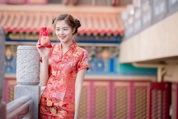 The Asian Chinese woman in Traditional Chinese hold Gift Bag