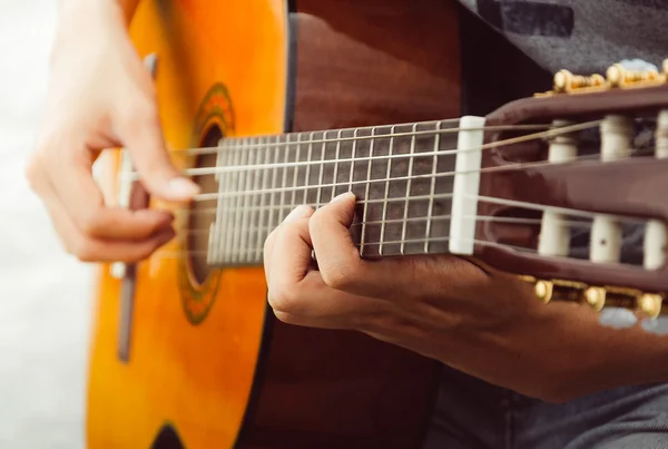 Hand playing on  guitar