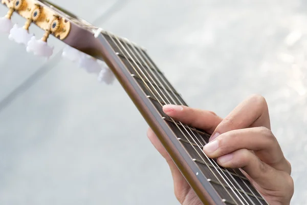 Hand playing on  guitar