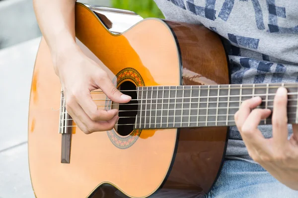 hand playing on  guitar