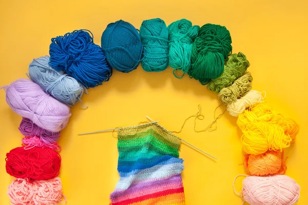 Threads of brightly colored yarn. Knitting. Balls of yarn.