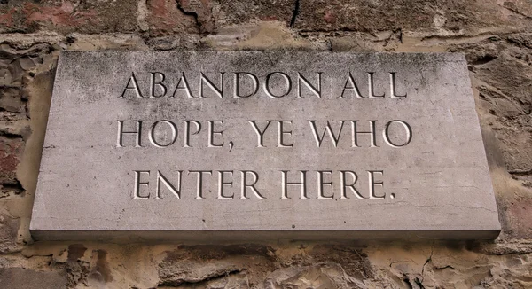 Abandon all hope, ye who enter here. From Dante\'s Divine Comedy. Engraved text.
