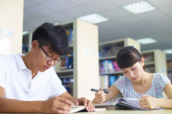 Young college students study together in the library