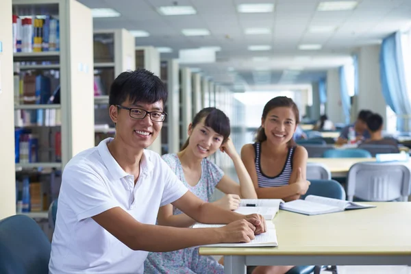 Young college students study together in the library