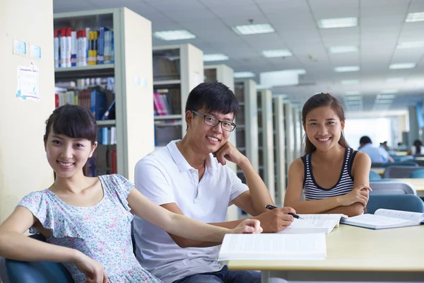 Young college students study together in the library