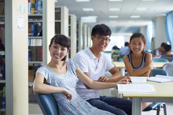 Young college students study together in the library