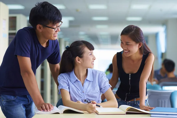 Young college students study together in the library