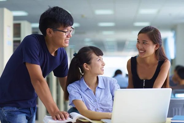 Young college students study together in the library