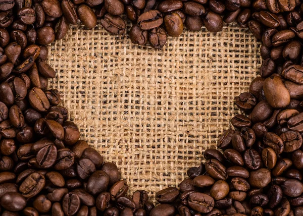 Coffee cup surrounded by toasted beans