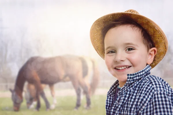 Portrait of a happy child is going to learn to ride a horse