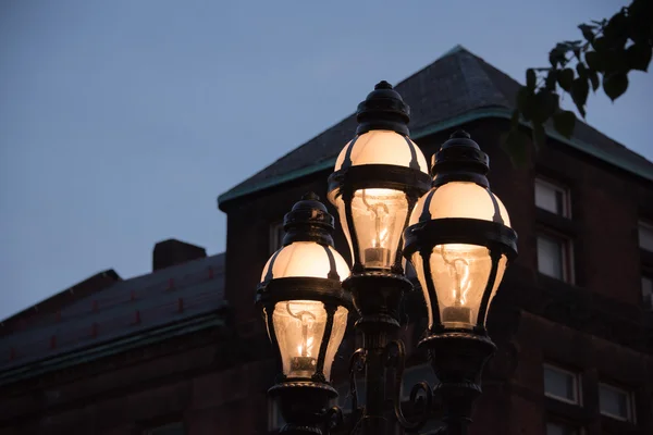Illuminated street light with three globes