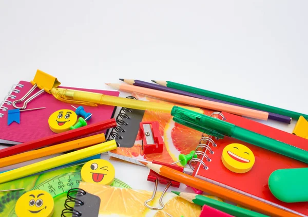 Pens, pencils, erasers, with smileys and a set of notebooks.