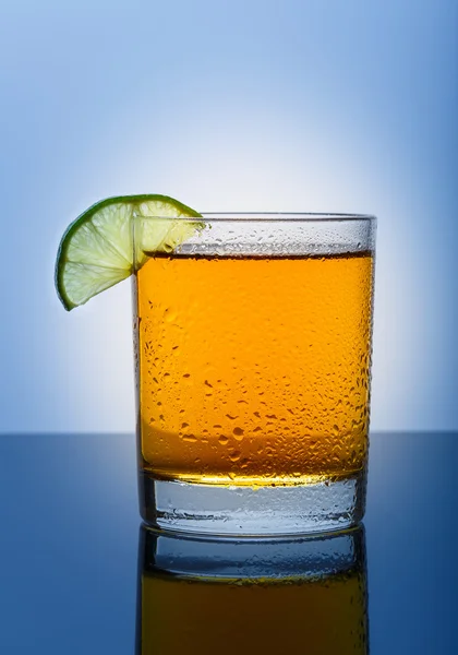 Cool glass of apple juice on a blue background