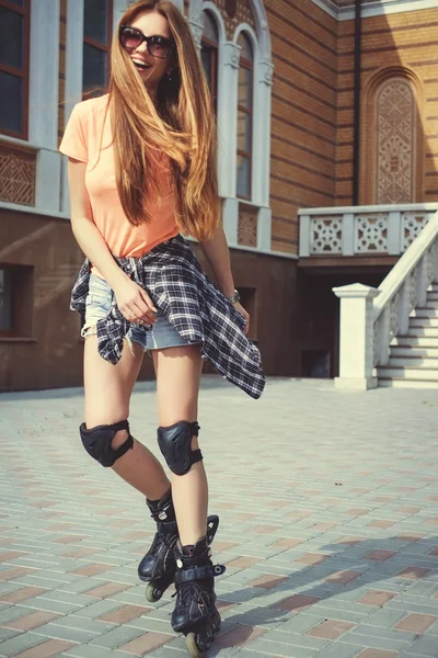 Happy redhead girl on the rollers