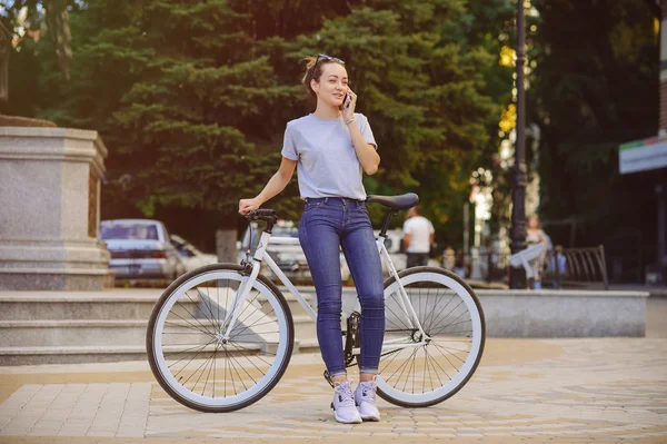 Girl with Bicycle talking on the phone