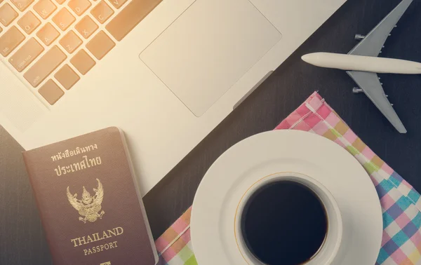 Business traveller equipments laying on desk.