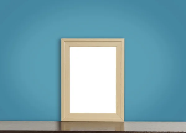 Blank wooden photo frame on rustic navy background.
