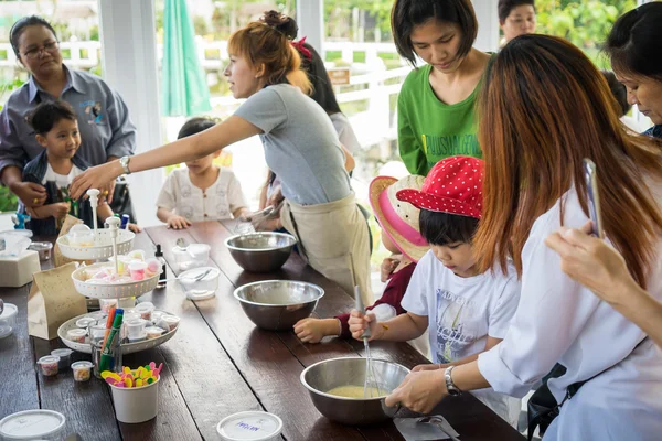 Family with small children are cooking in a Bakery cooking class.