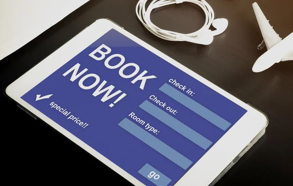 Book your hotel online using your Tablet or mobile devices now. Travel agency website on tablet. Online accommodation booking website on tablet screen.