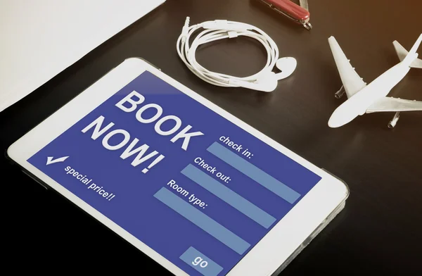 Book your hotel online using your Tablet or mobile devices now. Travel agency website on tablet. Online accommodation booking website on tablet screen.