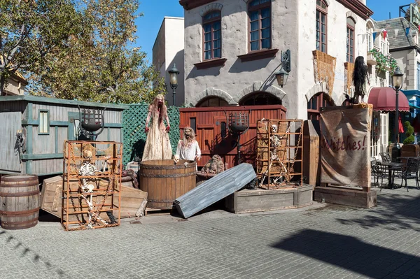 Halloween outdoor composition with skeletons, witches and coffin