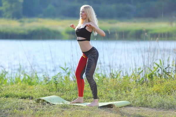 Young beautiful woman squats shows result press on stomach workout training wearing top