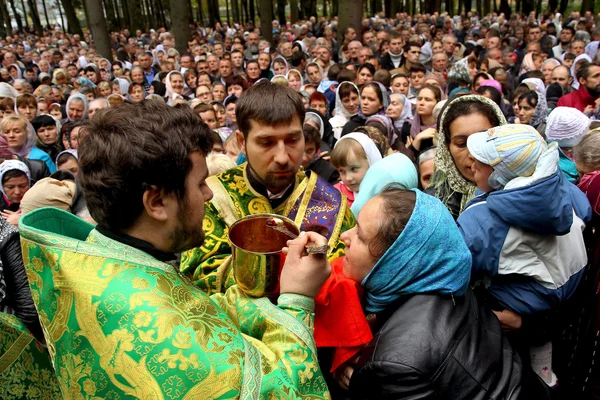 Priests conduct the communion rite during the church service