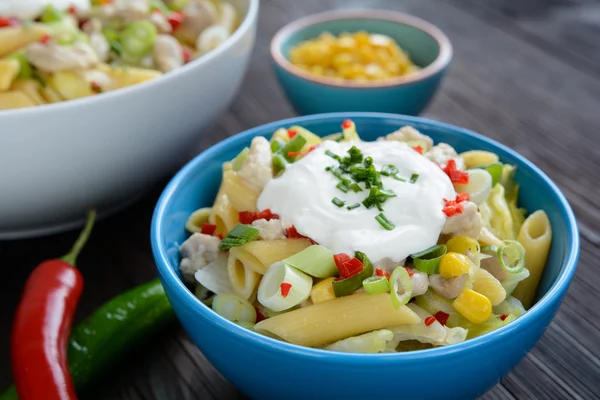 Pasta salad with fried chicken meat and vegetable