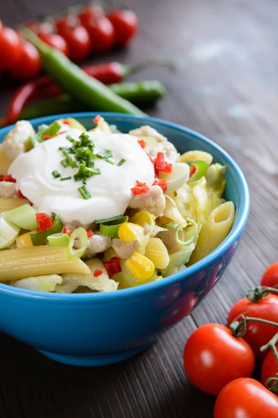 Pasta salad with fried chicken meat and vegetable