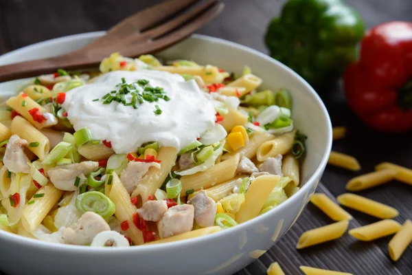 Pasta salad with fried chicken meat and vegetable