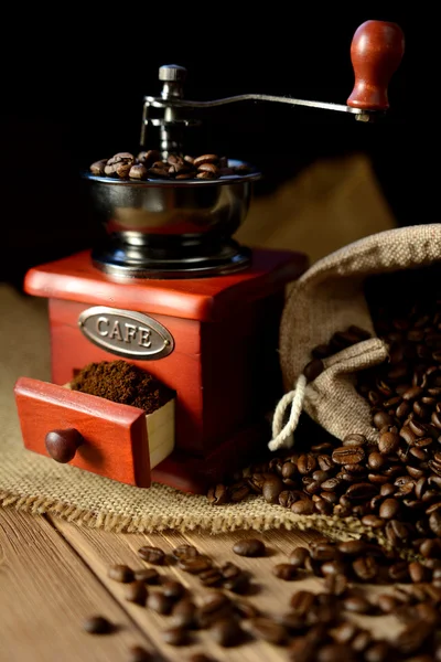 Coffee mill and coffee beans on dark background