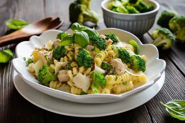 Pasta salad with chicken meat, broccoli, cheese and basil