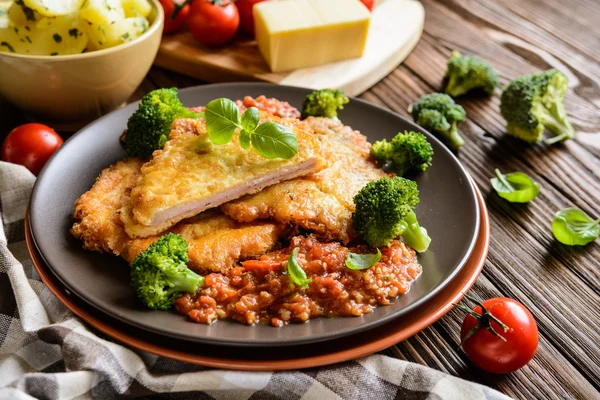 Pork Piccata with tomato sauce and steamed broccoli and boiled potatoes