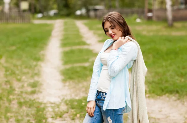 Pensive girl threw a jacket on his shoulder and looked down