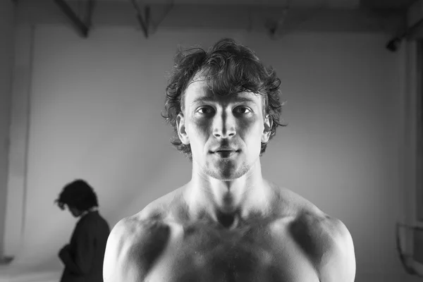 Portrait of young male dancer with girl on background/ Back to each other/ Relationship difficulties / Couple break up/ Black and white.